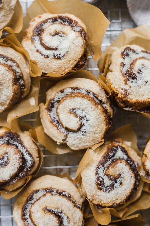 vegan pumpkin spice cinnamon rolls on a cooling rack